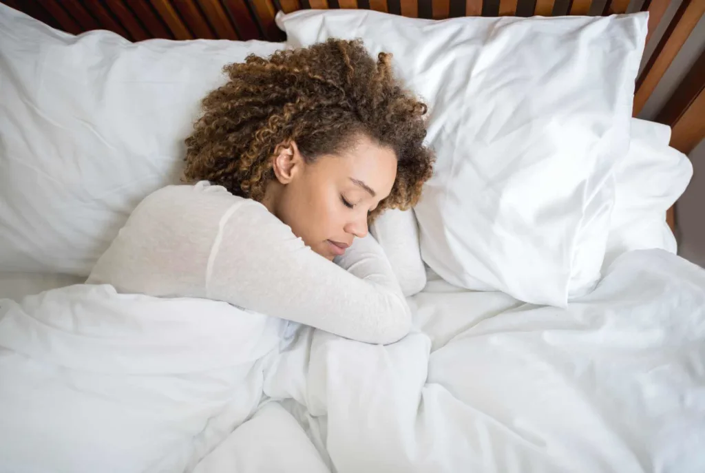 African-American woman sleeping in bed